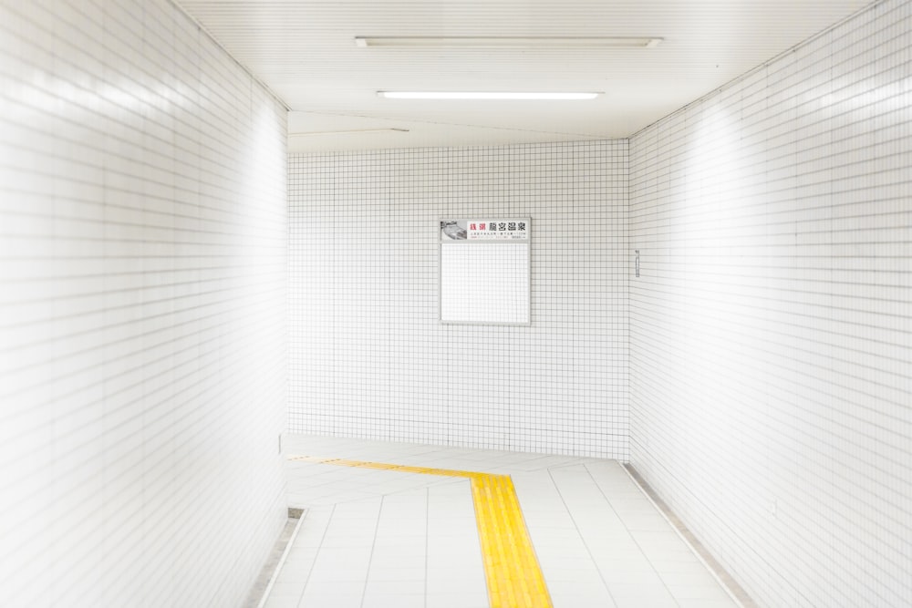 white and orange hallway with white wall