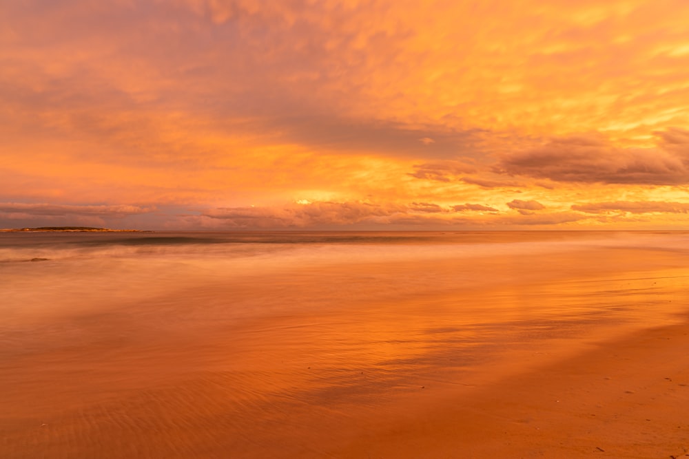 body of water during sunset