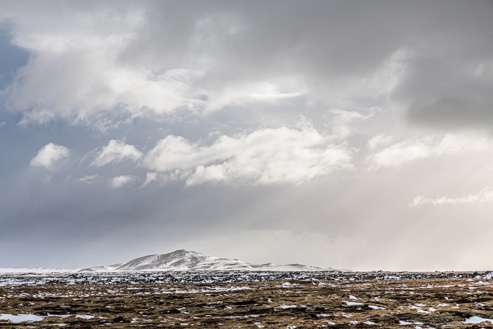 snow covered mountain under cloudy sky during daytime