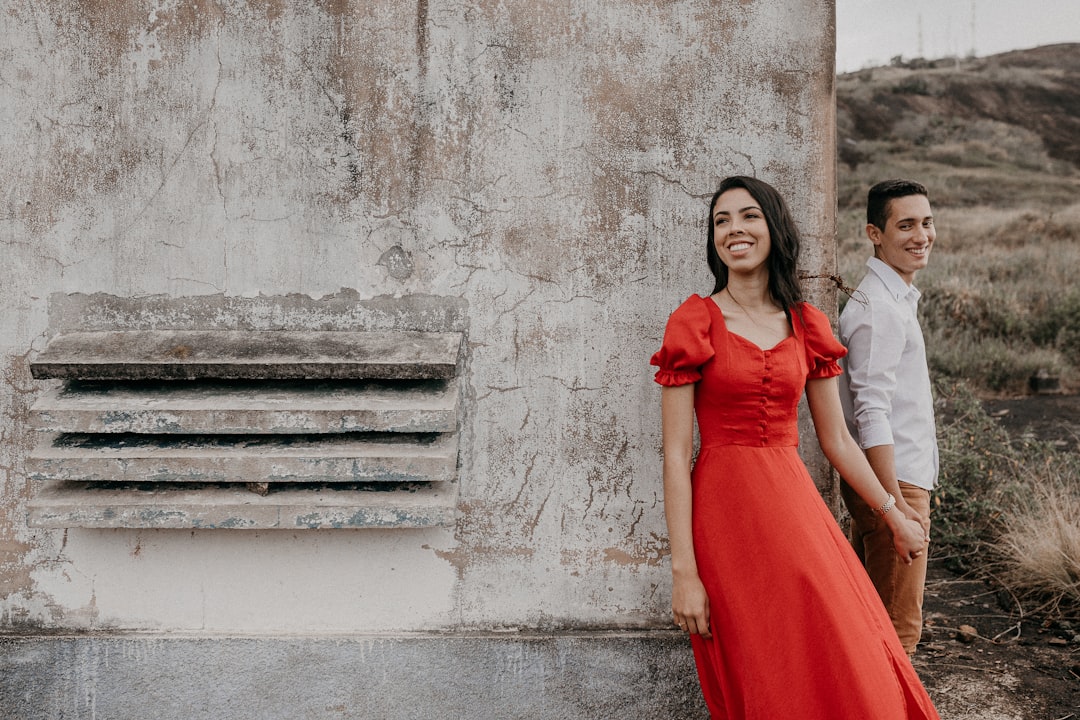 woman in red dress standing on gray concrete stairs