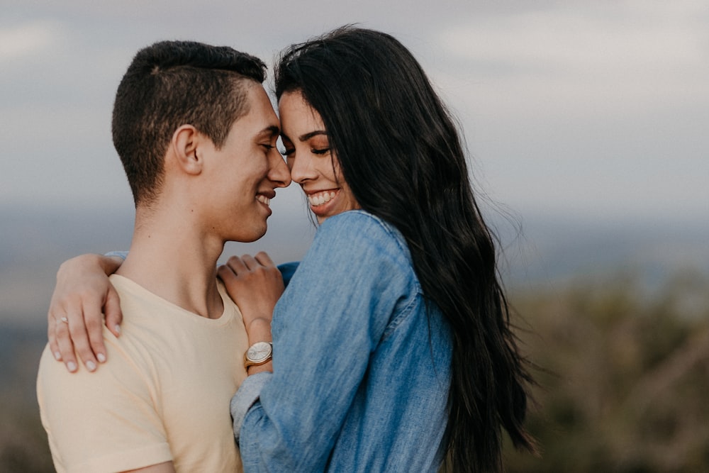 man and woman kissing during daytime