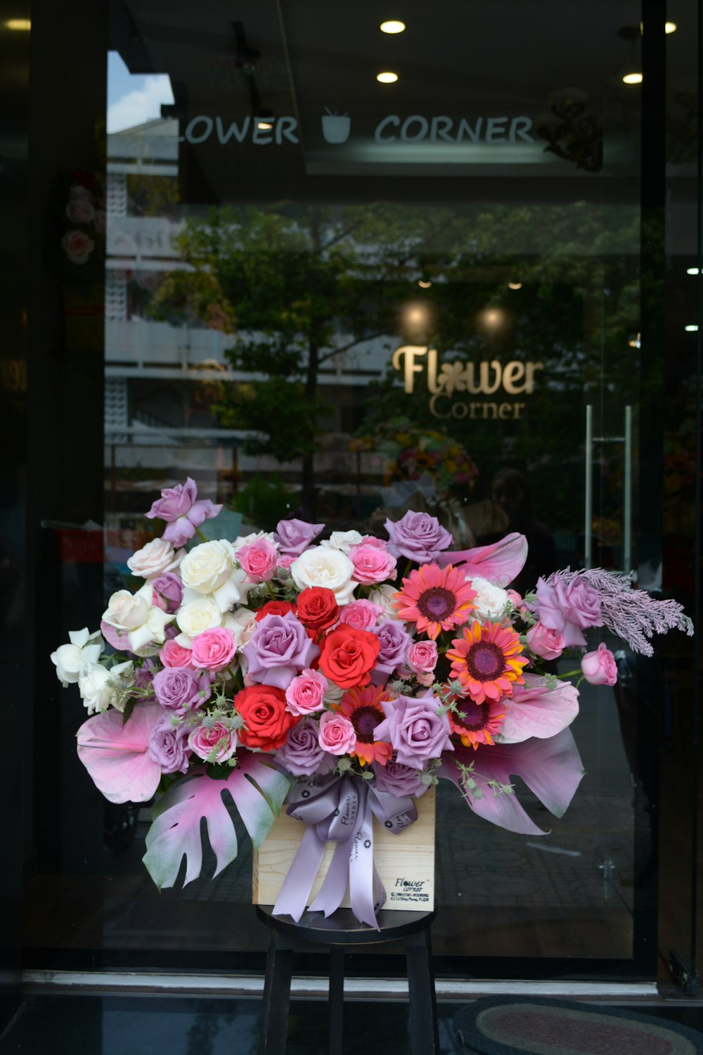 pink and white flowers on glass window