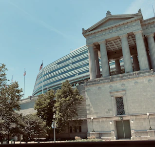 Elegant institutional building with international flags symbolizing global academic collaboration.