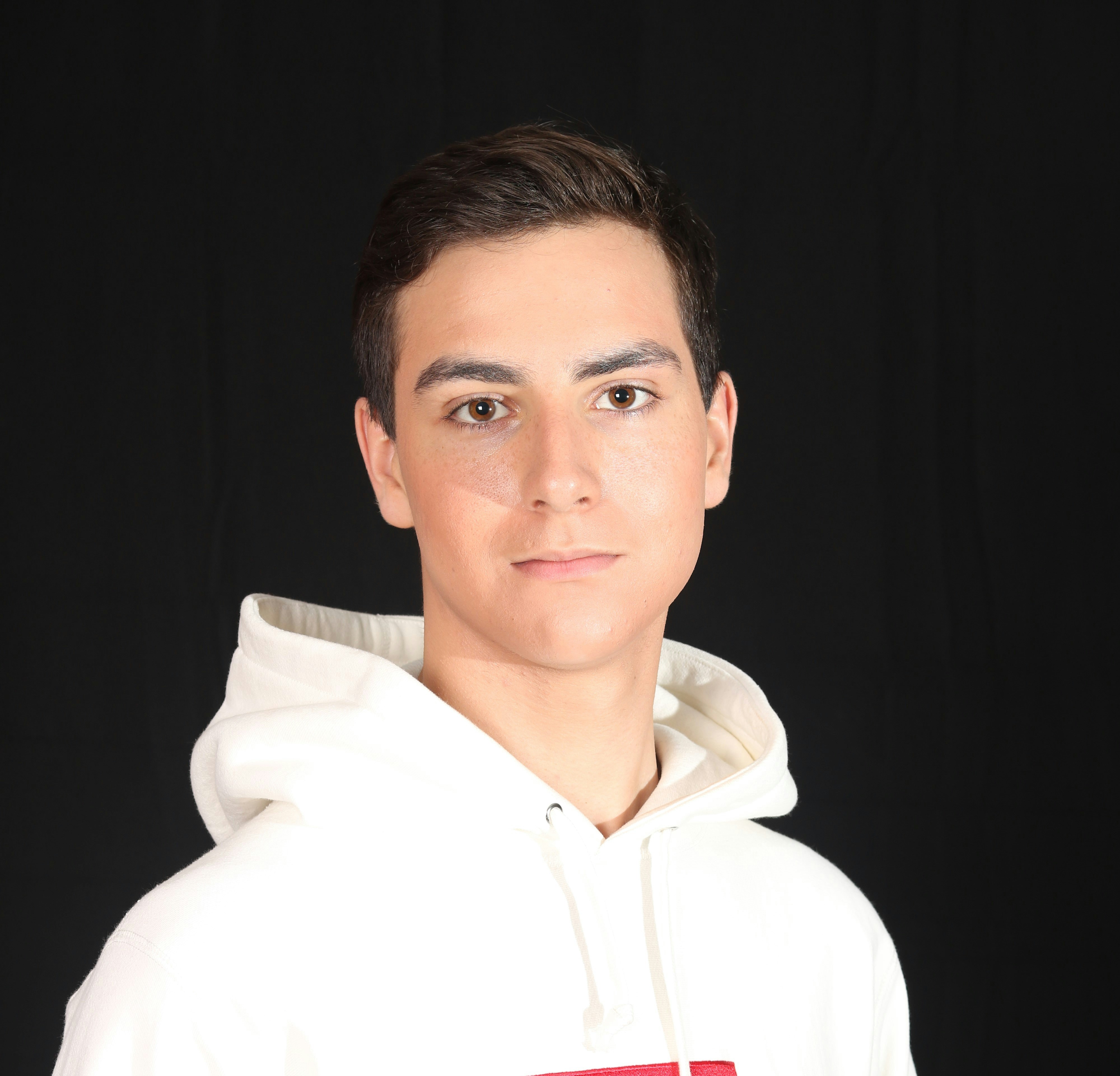 man in white hoodie smiling