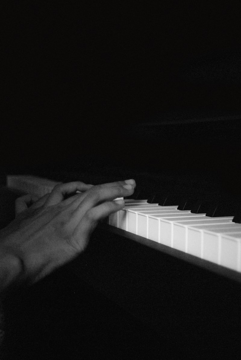 Person playing piano in black and white