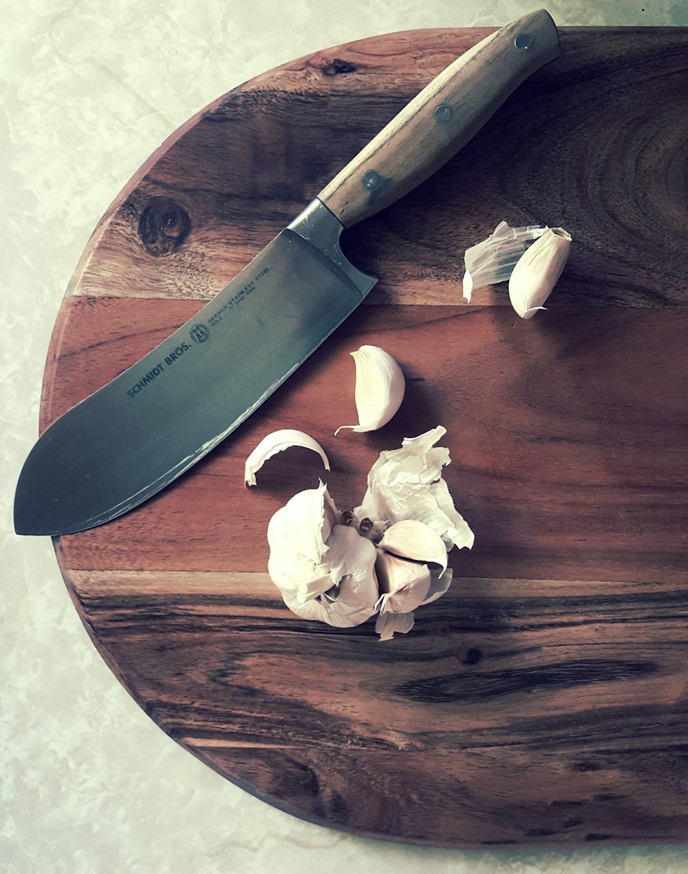 sliced garlic on brown wooden chopping board