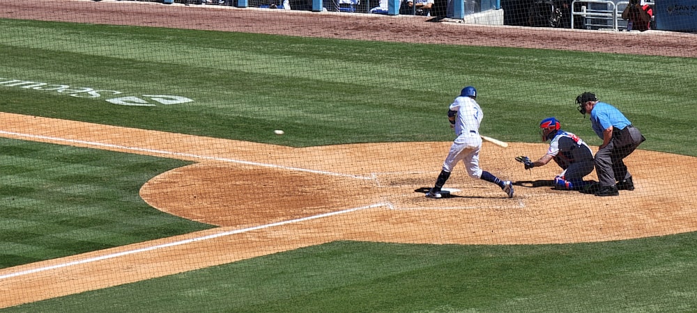 a baseball player swinging a bat at a ball