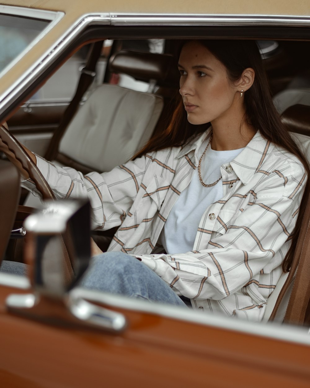 woman in white and black zip up jacket sitting on car seat