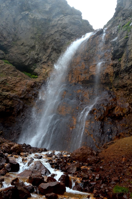 waterfalls on rocky mountain during daytime in Gegharot Armenia