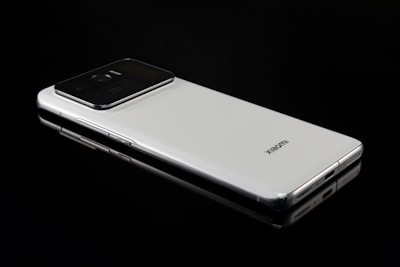 Close-up of a sleek black smartphone on a white background.