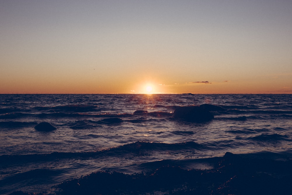 body of water during sunset