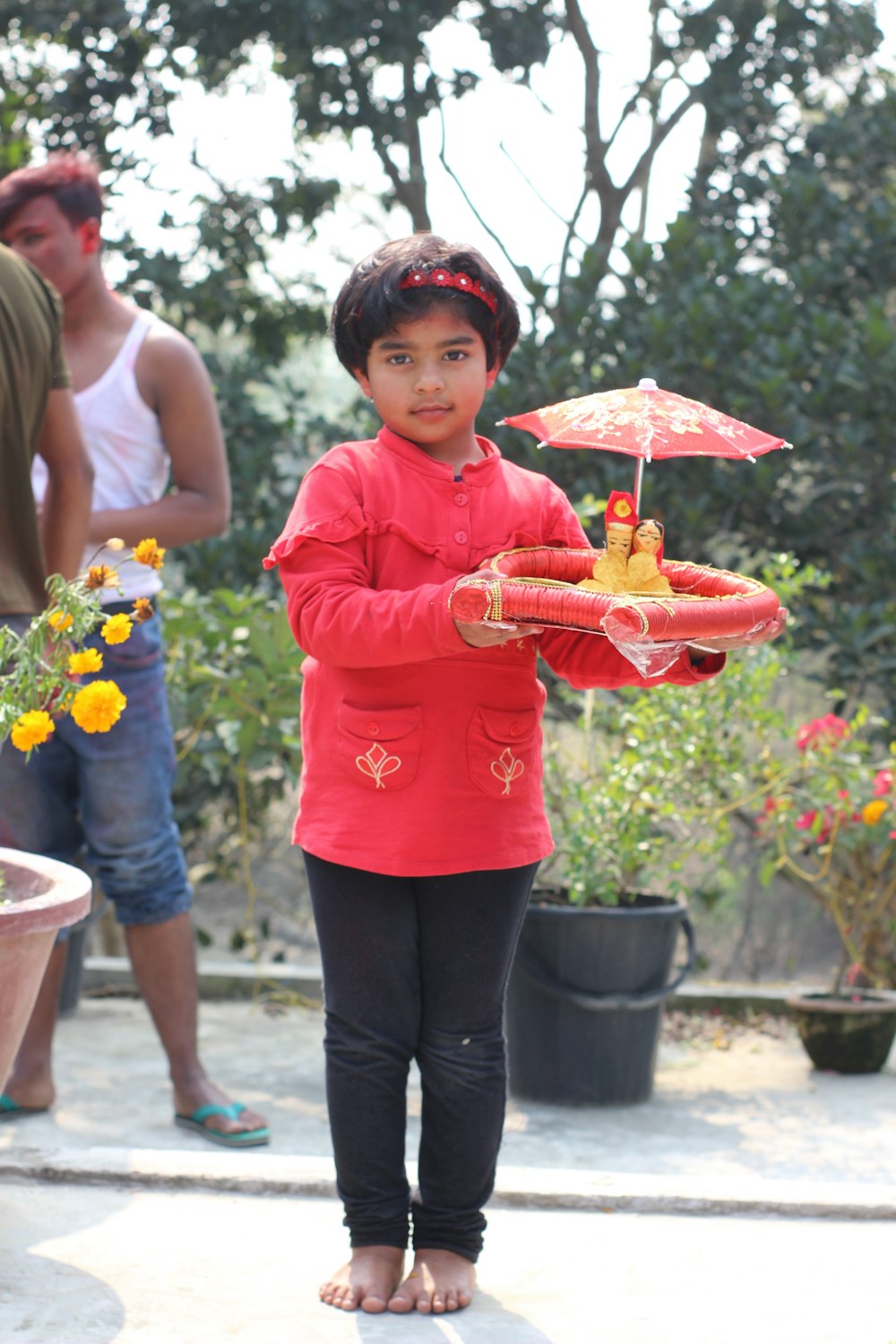 girl in red long sleeve shirt holding umbrella