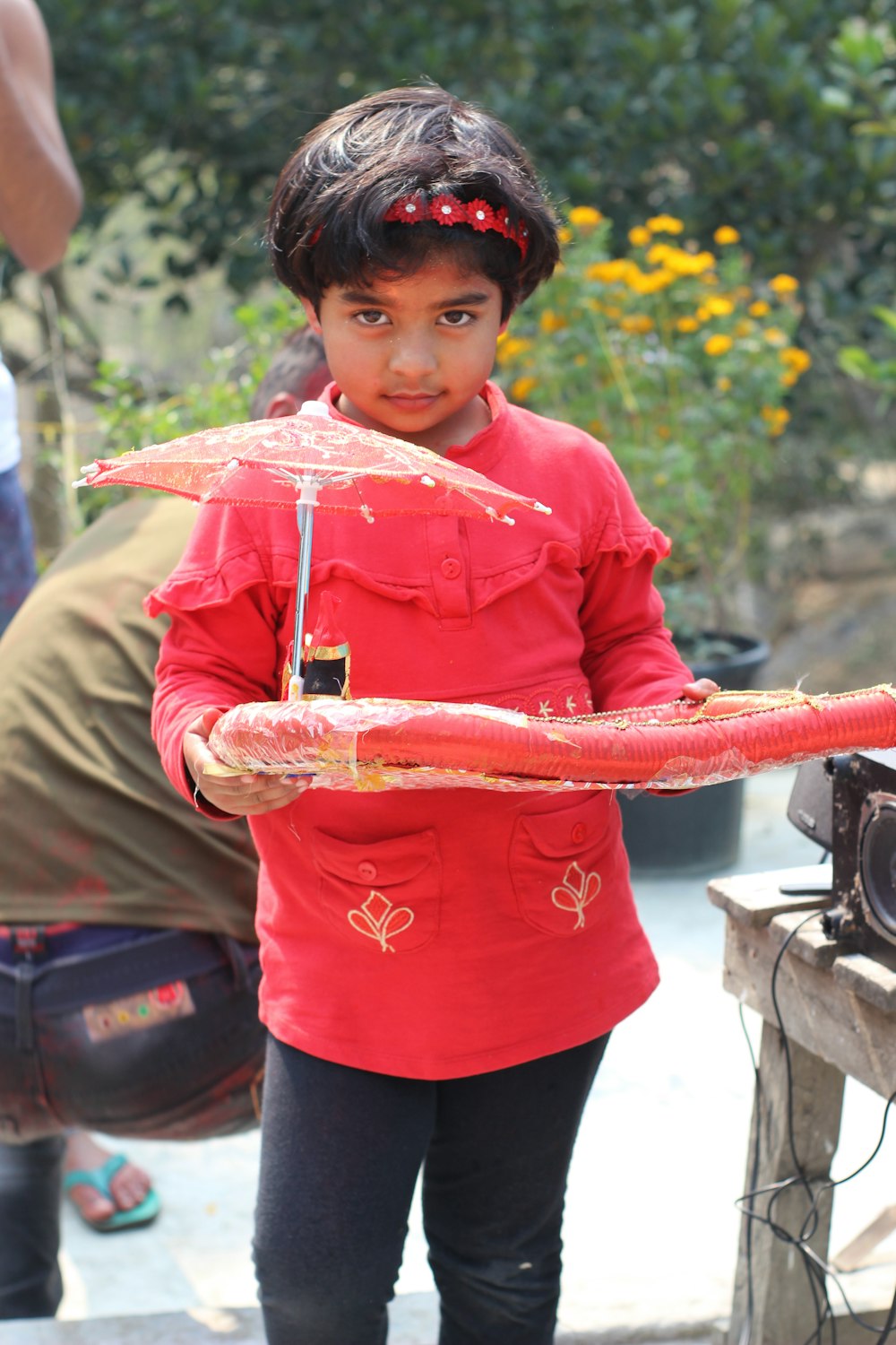 boy in pink button up long sleeve shirt holding red and white rope