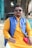 man in yellow cardigan wearing black sunglasses