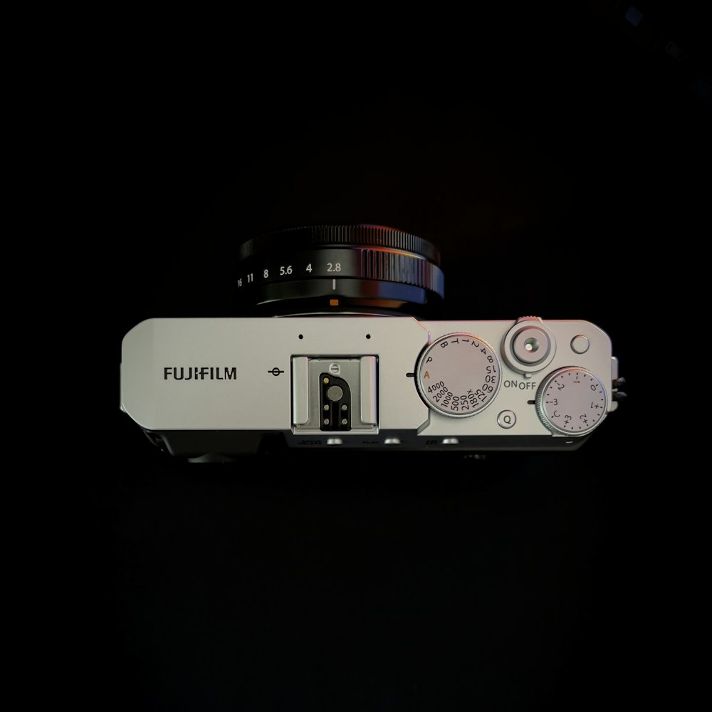 white and black camera with pink and white case