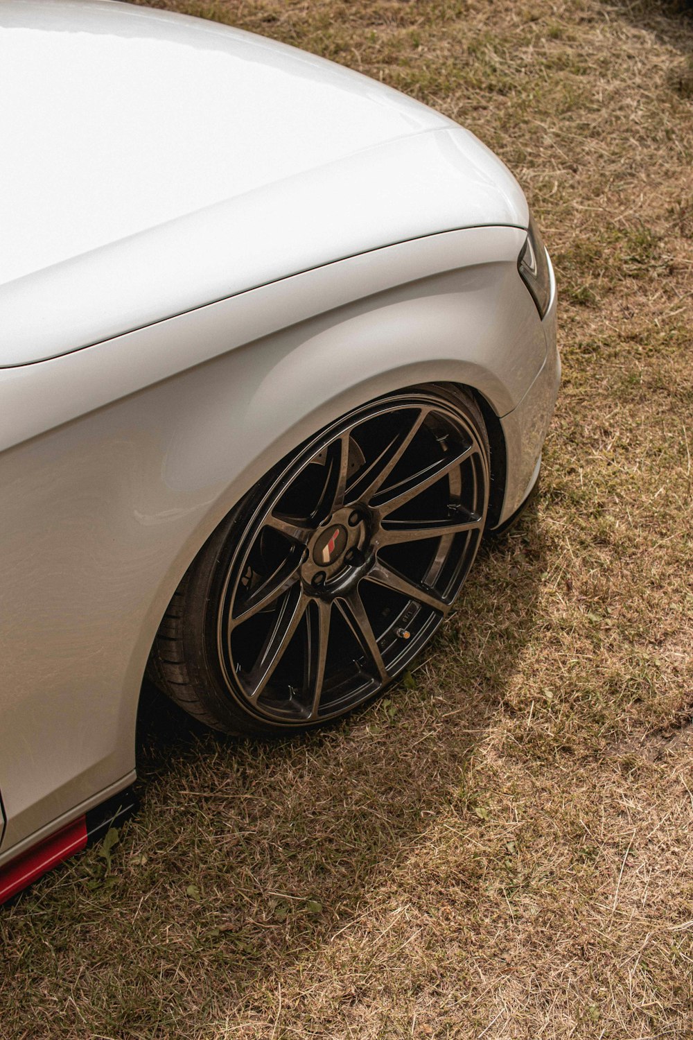 white car on brown grass field