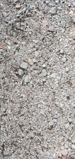 Close-up of crushed stone and gravel ready for delivery at a quarry site.