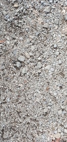 Close-up of crushed stone and gravel ready for delivery at a quarry site.