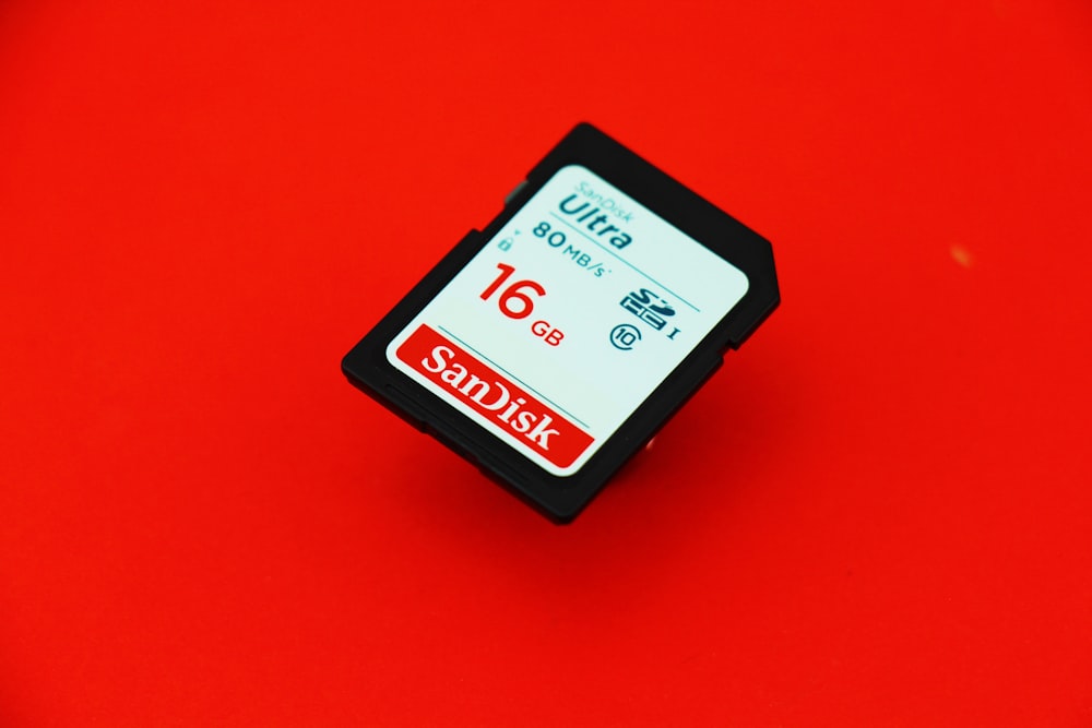 black hp ink cartridge on red surface