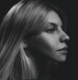 A black and white portrait with dramatic shadows.
