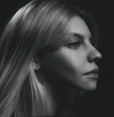 A striking black and white portrait showcasing intricate pencil shading.