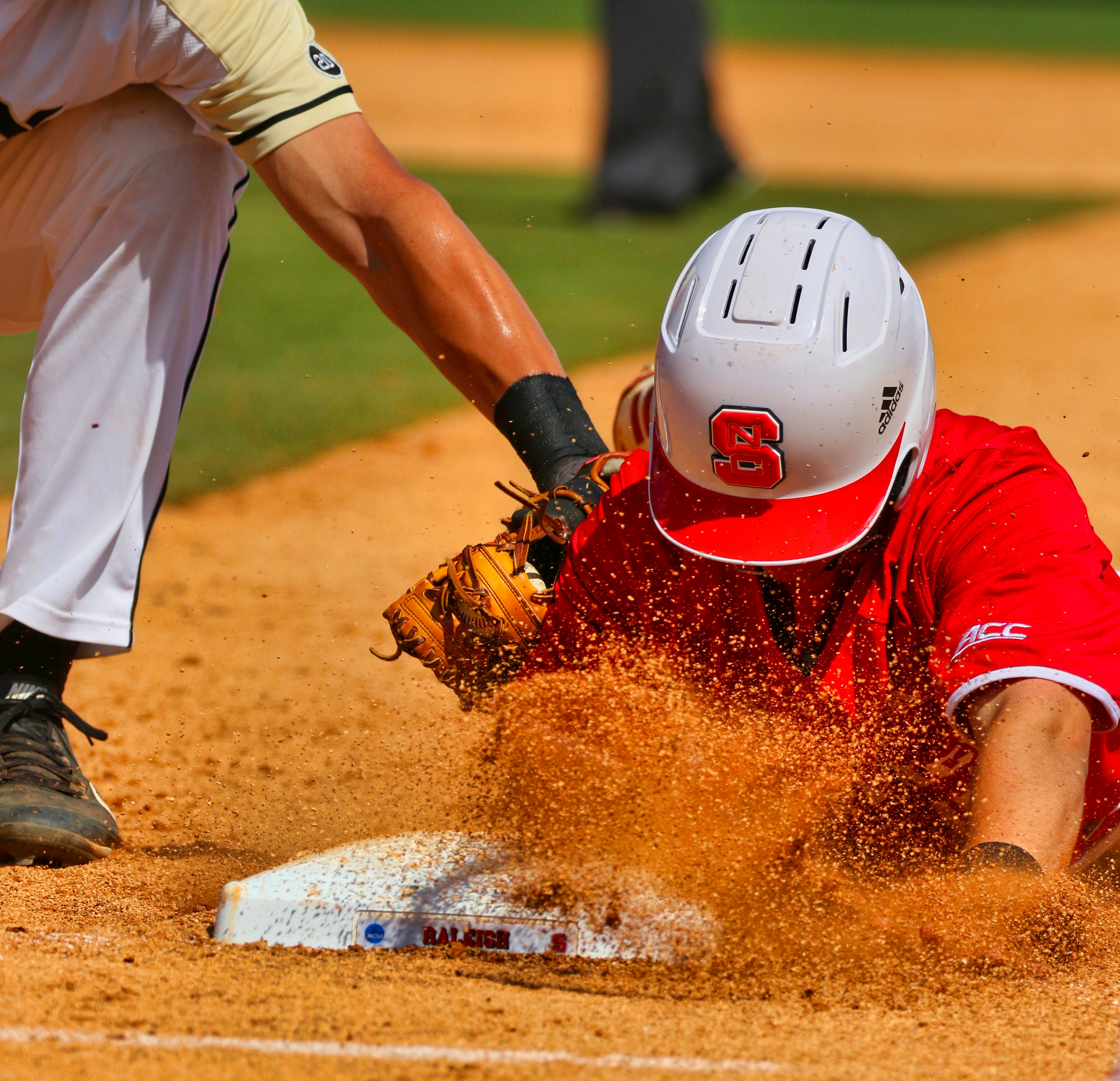 man in white and red jersey shirt and white pants playing baseball during daytime