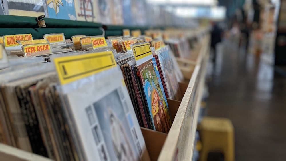 white and yellow books on brown wooden shelf