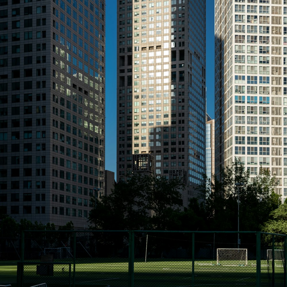 green grass field near high rise buildings during daytime