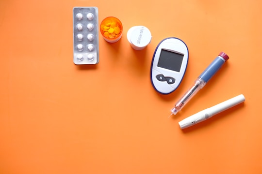white digital device beside white pen