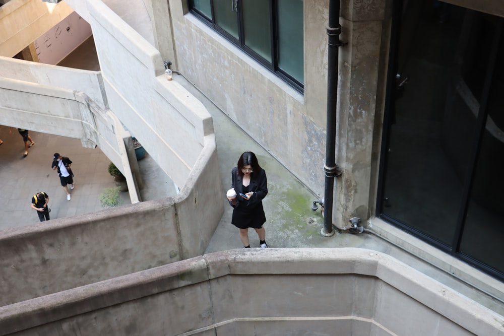 woman in black shirt and black pants sitting on concrete stairs