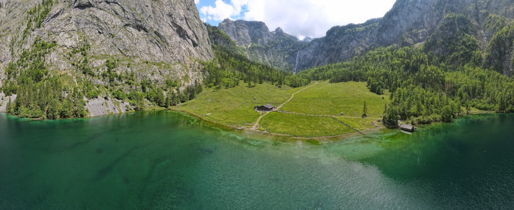 green lake in the middle of green mountains