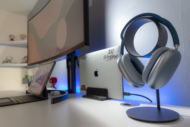 A modern workspace with multiple digital devices displaying entertainment content.