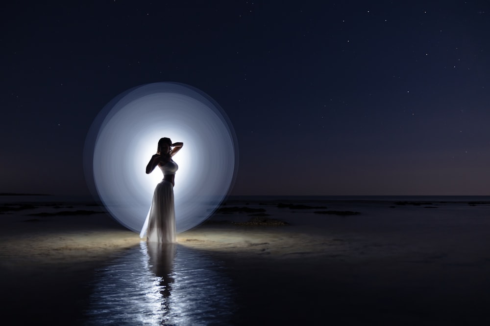 person standing on beach during night time