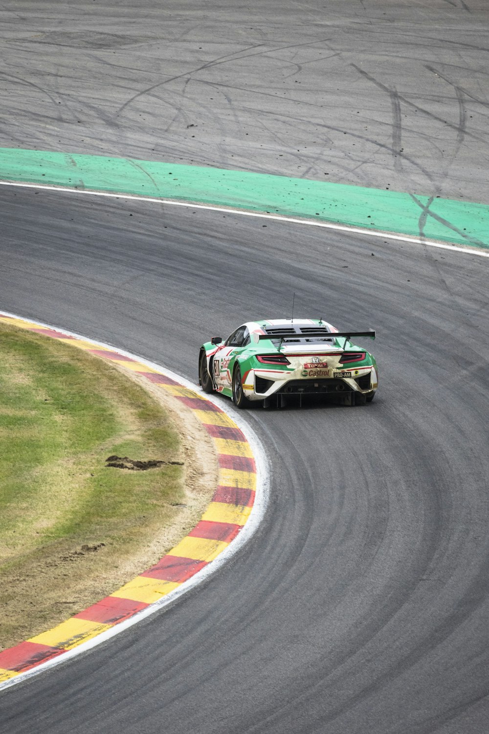 white and red racing car on track field during daytime