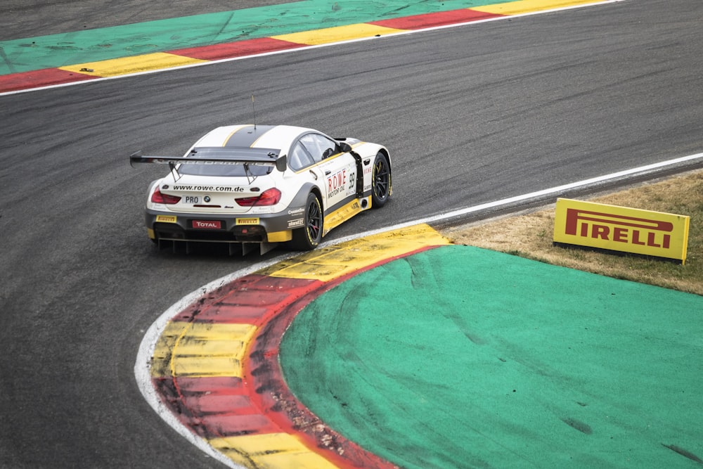 white and black porsche 911 on track field