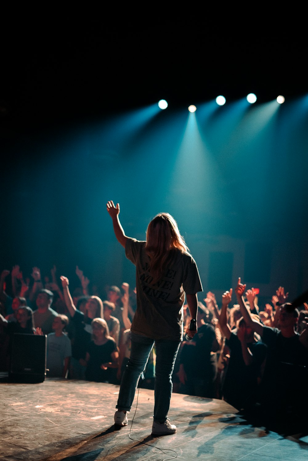 woman in black jacket standing on stage