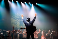 A director receiving applause as they accept their award on stage.