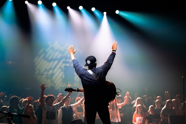 A proud student holding up their guitar after nailing a challenging song.