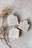 Close-up of dried lavender sprigs resting beside a rustic soap bar on a wooden surface.