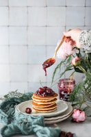 brown cupcake with pink rose on top