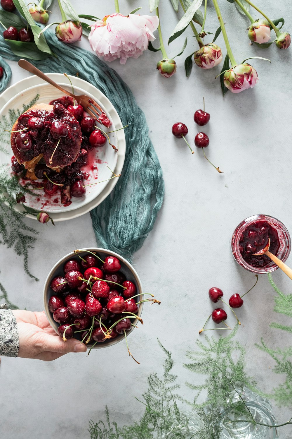 red cherries on white ceramic plate