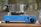 Close-up of camping cooking gear neatly arranged on a portable stove in a natural setting.