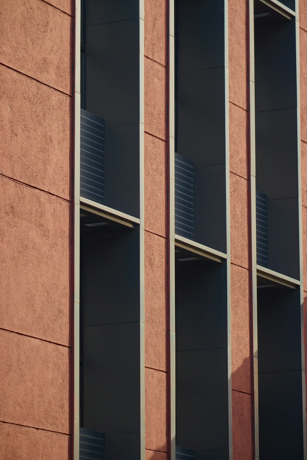 brown concrete building with glass windows