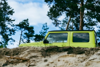 green suv on brown dirt road during daytime