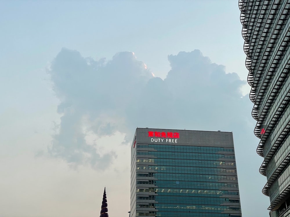 black and white high rise building under white clouds during daytime