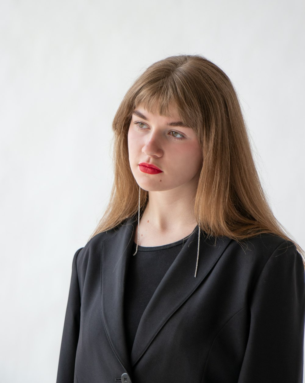 woman in black blazer with blonde hair