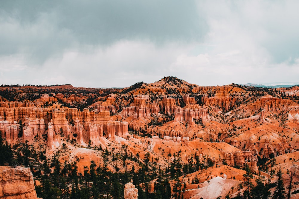 brown rocky mountain under cloudy sky during daytime