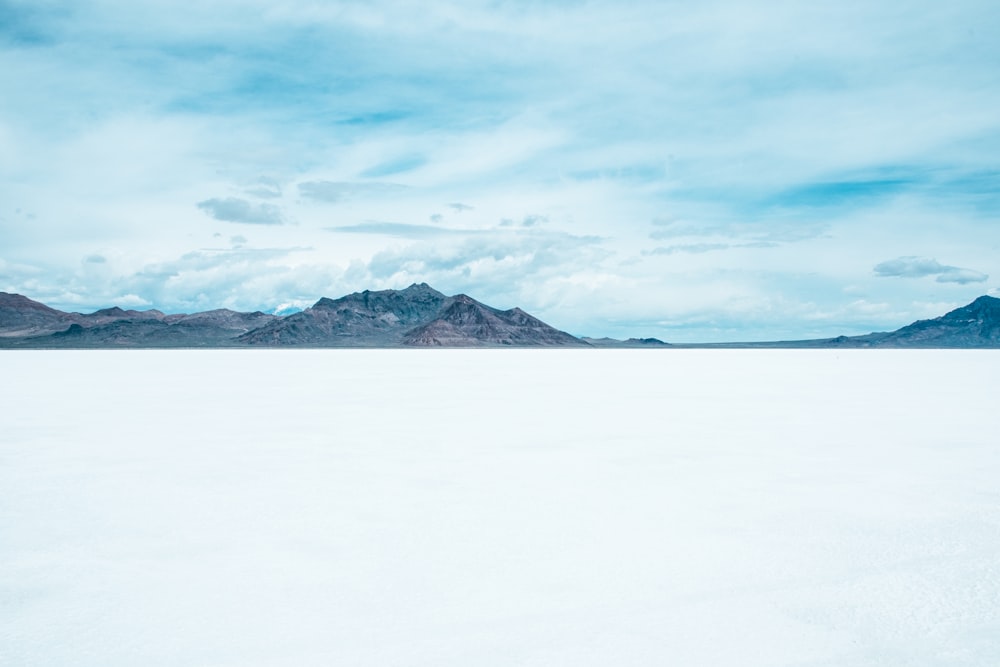 snow covered mountain under cloudy sky during daytime