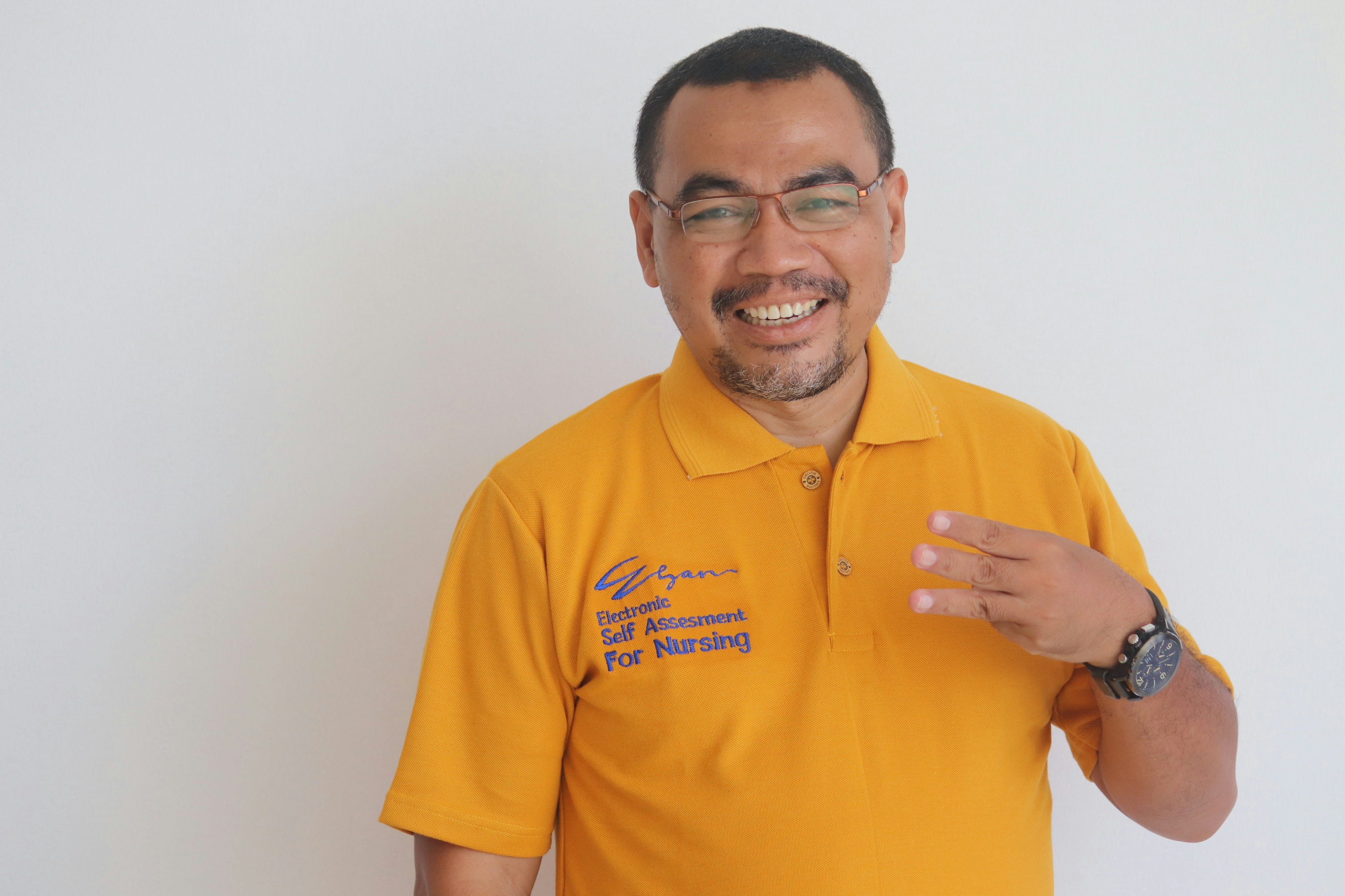a person wearing a yellow shirt is smiling and excited