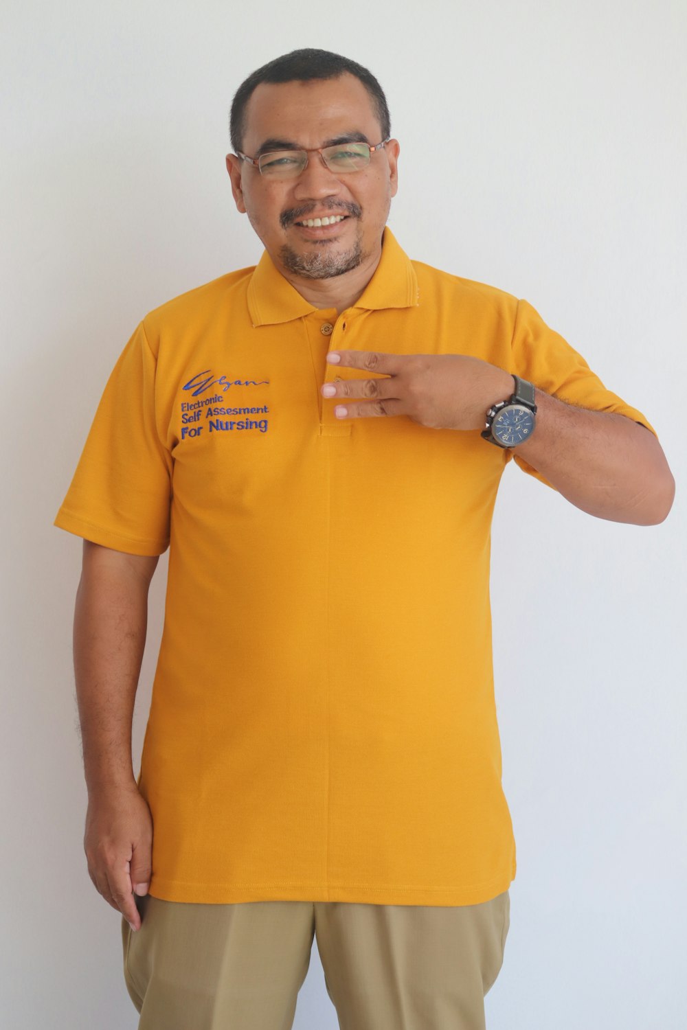 man in yellow polo shirt wearing black round analog watch